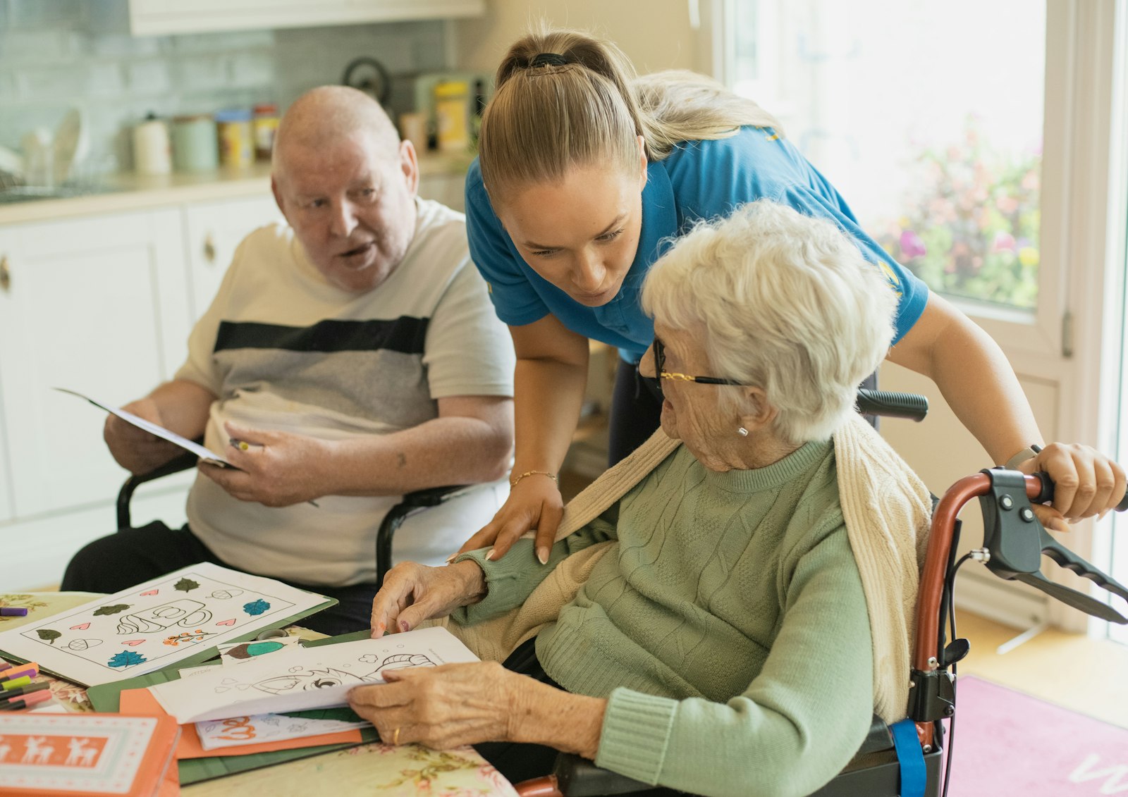 Care staff with residents in an aged care activity room